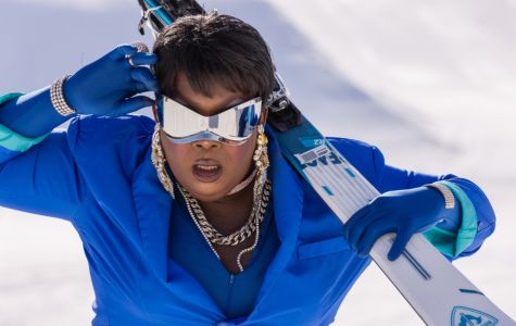 Drag Queen posing for the camera in a blue suit